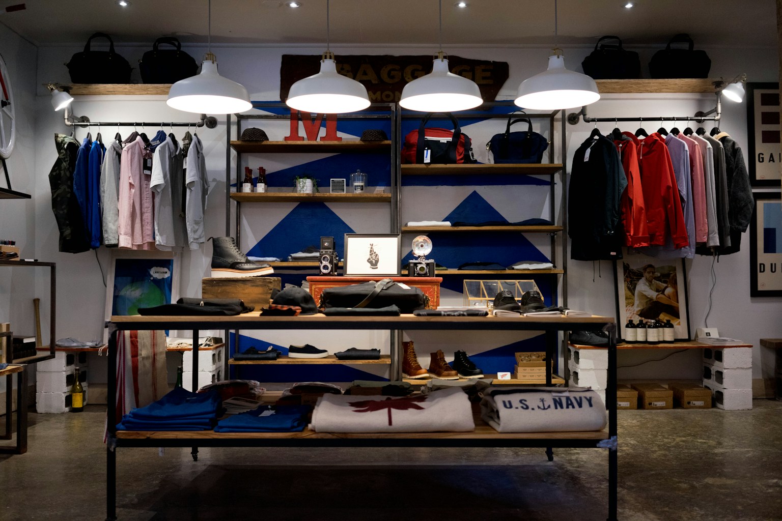 Shop interior with clothing racks, stocked shelves, and pendant lights — demo stock photo